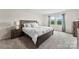 The main bedroom features a bed with nightstands, and a bright window at 11518 Solstice Way, Huntersville, NC 28078