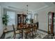 Elegant dining room with wainscoting, chandelier, and ample natural light at 11718 Preservation Ln, Charlotte, NC 28278
