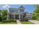 Beautiful two-story home featuring manicured landscaping and a welcoming front porch at 11718 Preservation Ln, Charlotte, NC 28278
