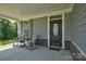 Inviting front porch with rocking chairs, perfect for relaxing outdoors at 11718 Preservation Ln, Charlotte, NC 28278