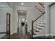Spacious hallway with hardwood floors and elegant staircase at 11718 Preservation Ln, Charlotte, NC 28278