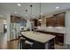 Spacious kitchen featuring an island with bar seating and stainless appliances at 11718 Preservation Ln, Charlotte, NC 28278