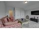 Comfortable living room features plush patterned sofa, TV, and large closets at 11718 Preservation Ln, Charlotte, NC 28278