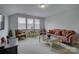 Inviting living room is styled with comfortable seating arrangements and natural light through the window at 11718 Preservation Ln, Charlotte, NC 28278