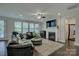 Inviting living room with fireplace, dark wood floors, and modern decor at 11718 Preservation Ln, Charlotte, NC 28278
