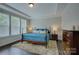Comfortable main bedroom with tray ceiling, plush rug, and ample natural light at 11718 Preservation Ln, Charlotte, NC 28278