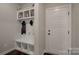 Welcoming mudroom boasts built-in storage with shelving and bench, perfect for organization and convenience at 11718 Preservation Ln, Charlotte, NC 28278