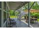 Charming covered patio with seating area, outdoor stairs, and stamped concrete floors at 11718 Preservation Ln, Charlotte, NC 28278