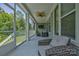Relaxing screened-in porch with comfortable wicker seating and ceiling fan at 11718 Preservation Ln, Charlotte, NC 28278