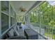 Relaxing screened-in porch with comfortable wicker seating and ceiling fan at 11718 Preservation Ln, Charlotte, NC 28278