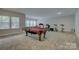 Bright game room boasts a billiards table and exercise equipment with natural light at 11718 Preservation Ln, Charlotte, NC 28278