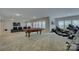 Recreation room features a pool table, exercise equipment, and a cozy seating area at 11718 Preservation Ln, Charlotte, NC 28278