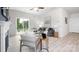 Bright living room features a sliding glass door, ceiling fan and neutral decor at 12012 Zazu Way, Charlotte, NC 28215