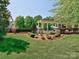 Picturesque backyard boasting manicured lawns and a charming pergola, creating a serene outdoor space for relaxation and entertainment at 13421 Copley Square Dr, Huntersville, NC 28078