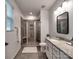 Bright bathroom featuring a tiled shower with a bench and ample counter space at 13421 Copley Square Dr, Huntersville, NC 28078