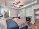 Bedroom boasts a fireplace, built in bookshelves and an ensuite bath with tile shower at 13421 Copley Square Dr, Huntersville, NC 28078