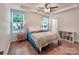 Bright bedroom featuring hardwood floors, tray ceilings, and ample natural light at 13421 Copley Square Dr, Huntersville, NC 28078