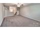 Spacious bonus room with plush carpeting, natural light and high ceilings at 13421 Copley Square Dr, Huntersville, NC 28078