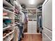 Walk-in closet providing an organized shelving and hanging system at 13421 Copley Square Dr, Huntersville, NC 28078