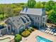 Beautiful clubhouse featuring a swimming pool, lounging area, and meticulously landscaped grounds for residents to enjoy at 13421 Copley Square Dr, Huntersville, NC 28078