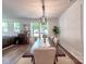 Bright dining room with a farmhouse table, modern chandelier, and views of the landscaped yard at 13421 Copley Square Dr, Huntersville, NC 28078