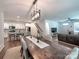 Open-concept dining room features modern lighting, a farmhouse table, and is adjacent to the kitchen at 13421 Copley Square Dr, Huntersville, NC 28078