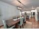 Dining area showcases modern light fixture and opens into the kitchen with granite countertops and stainless appliances at 13421 Copley Square Dr, Huntersville, NC 28078