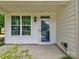 Inviting front porch features classic design elements, ample natural light, and pleasant views at 13421 Copley Square Dr, Huntersville, NC 28078