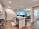 Modern kitchen with white cabinets, stainless steel appliances, and granite countertops is open to the dining and living areas at 13421 Copley Square Dr, Huntersville, NC 28078
