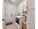 Efficient laundry room showcasing modern appliances and extra storage at 13421 Copley Square Dr, Huntersville, NC 28078