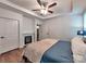 Relaxing primary bedroom featuring a fireplace, tray ceiling, and neutral colors at 13421 Copley Square Dr, Huntersville, NC 28078