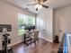 Bright home office with large window, modern desk, and ceiling fan at 13421 Copley Square Dr, Huntersville, NC 28078