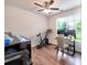 A comfortable home office features natural light, a ceiling fan, and space for exercise equipment at 13421 Copley Square Dr, Huntersville, NC 28078