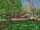 Community playground offering swings, slides, and climbing structures within a secure fenced area for outdoor enjoyment at 13421 Copley Square Dr, Huntersville, NC 28078