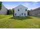 The spacious backyard of this two-story home features a lush green lawn and mature trees at 1457 Matthew Allen Cir, Kannapolis, NC 28081