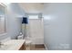 Well-lit bathroom with a single sink vanity, toilet, and shower-tub combination with a shower curtain at 1457 Matthew Allen Cir, Kannapolis, NC 28081