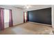 Spacious bedroom with neutral carpet and a black accent wall at 1457 Matthew Allen Cir, Kannapolis, NC 28081