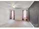 Empty bedroom showcasing large windows and neutral carpet at 1457 Matthew Allen Cir, Kannapolis, NC 28081