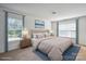 Bright staged bedroom with large bed, matching bedside tables, and two windows with decorative blue curtains at 1457 Matthew Allen Cir, Kannapolis, NC 28081