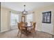 Traditional dining room with wood table, chairs, pendant lighting, and large windows at 1457 Matthew Allen Cir, Kannapolis, NC 28081