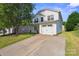 Charming two-story home with a two car garage, long driveway and a well-maintained lawn at 1457 Matthew Allen Cir, Kannapolis, NC 28081
