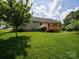 Beautiful backyard featuring a deck, lush lawn, mature trees, and tranquil setting at 1505 Moss Springs Rd, Albemarle, NC 28001