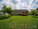 Spacious, grassy backyard with mature shade tree and deck offers serene outdoor retreat at 1505 Moss Springs Rd, Albemarle, NC 28001