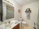 Bathroom featuring a sink, toilet, and shower with a patterned shower curtain at 1505 Moss Springs Rd, Albemarle, NC 28001