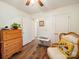 Bedroom featuring hardwood floors, a dresser, a closet, and a wicker chair at 1505 Moss Springs Rd, Albemarle, NC 28001