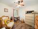 Bedroom featuring hardwood floors, a ceiling fan, and a sewing machine on a small table at 1505 Moss Springs Rd, Albemarle, NC 28001