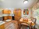 Spacious eat-in kitchen with wooden cabinets, dining table, and decorative plate display at 1505 Moss Springs Rd, Albemarle, NC 28001