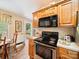 Kitchen features wood cabinetry, stainless steel stove, view to the deck, and dining area at 1505 Moss Springs Rd, Albemarle, NC 28001