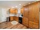 Spacious kitchen with wooden cabinets, stainless steel trash can, and wood-look flooring at 1505 Moss Springs Rd, Albemarle, NC 28001