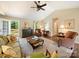 Spacious living room with vaulted ceilings, ceiling fan, neutral carpet and a view of the deck through French doors at 1505 Moss Springs Rd, Albemarle, NC 28001